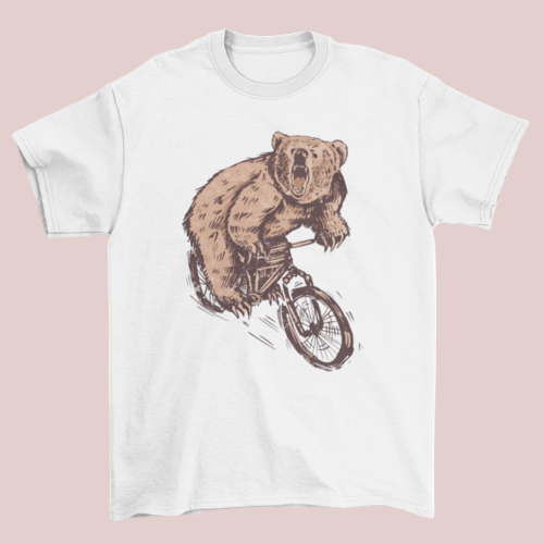 White t-shirt with a bear riding a bicycle graphic on a white background