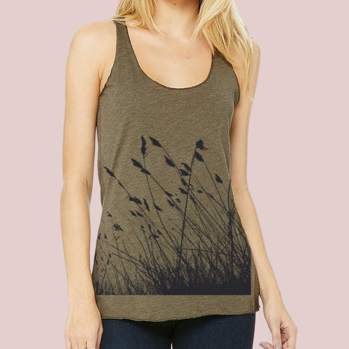 Green tank top with black floral pattern worn by a model on a white background