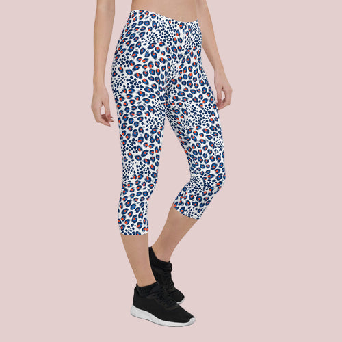 Person wearing blue and red leopard print capri pants on a white background