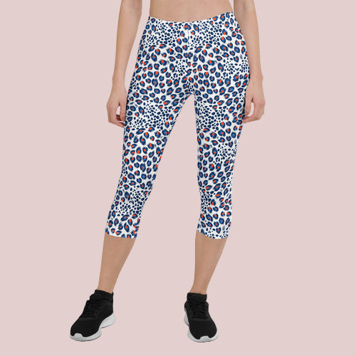 Capri leggings with a blue and red pattern worn by a person on a white background