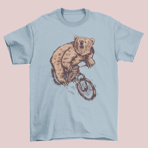 Light blue t-shirt with a bear riding a bicycle graphic on a white background