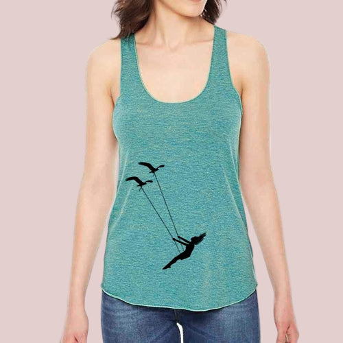 Teal tank top with black silhouette design of a person and two birds on a white background