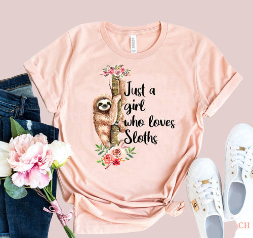 Pink t-shirt with sloth graphic and text 'Just a girl who loves Sloths' on a white background.